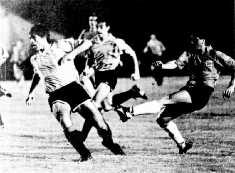 El atacante costarricense Norman "Pin" Gómez (derecha) remata sin éxito ante la vigilancia del capitán uruguayo, Eber Moas, durante el amistoso ganado 1-0 por los charrúas, el 14 de mayo de 1991 en el Estadio Nacional de San José (foto de la Asociación Uruguaya de Fútbol).